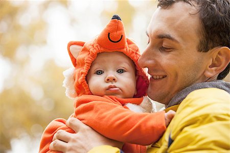 people animal cuddle - Young Caucasian man and his little son in fox costume in autumn park Stock Photo - Budget Royalty-Free & Subscription, Code: 400-07329345