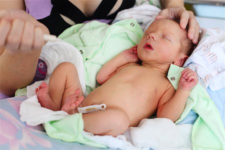 Mother feeding newborn baby milk with syringe Stock Photo - Budget Royalty-Free & Subscription, Code: 400-07329464