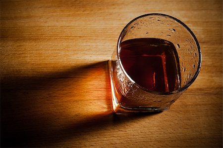 glass of whiskey on a wooden table Fotografie stock - Microstock e Abbonamento, Codice: 400-07320136