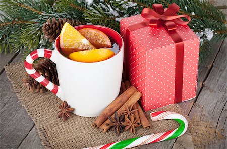 Christmas mulled wine with spices, gift box and snowy fir tree on wooden table Stock Photo - Budget Royalty-Free & Subscription, Code: 400-07320158