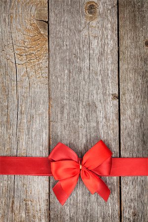 Wooden background with red bow and ribbon with copy space Stock Photo - Budget Royalty-Free & Subscription, Code: 400-07320193
