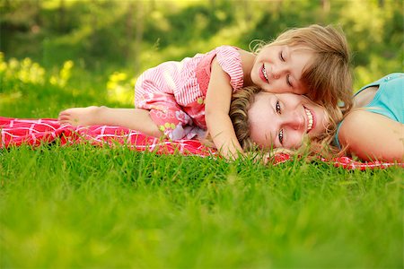 a Mama and her little daughter on the grass Stock Photo - Budget Royalty-Free & Subscription, Code: 400-07320530