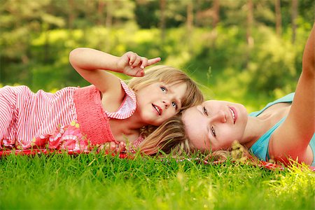 a Mama and her little daughter on the grass Stock Photo - Budget Royalty-Free & Subscription, Code: 400-07320531