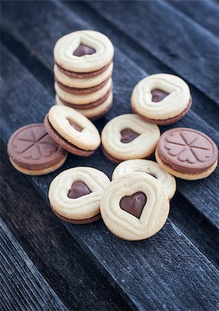 Heart shaped cut out cookies with chocolate filling on the wooden table Stock Photo - Budget Royalty-Free & Subscription, Code: 400-07320821
