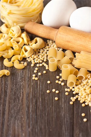 Assortment of dry pasta on a kitchen table with flour and rolling pin. Stock Photo - Budget Royalty-Free & Subscription, Code: 400-07321614