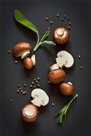 simsearch:400-07430898,k - Fresh mushrooms with spices and herbs on a black board. Photographie de stock - Aubaine LD & Abonnement, Code: 400-07321667