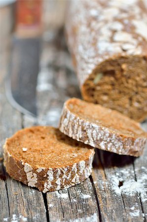 Sliced loaf of rye bread on rustic wooden background Stock Photo - Budget Royalty-Free & Subscription, Code: 400-07321769