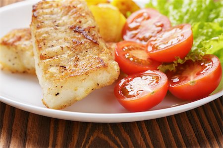 roasted fish - roasted codfish fillet with vegetables, selective focus Stock Photo - Budget Royalty-Free & Subscription, Code: 400-07321760