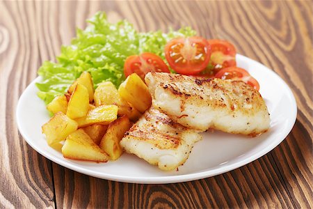 roasted fish - roasted codfish fillet with vegetables, selective focus Stock Photo - Budget Royalty-Free & Subscription, Code: 400-07321762
