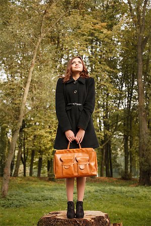 full length portrait of young female standing on stump in forest with bag looking away Stock Photo - Budget Royalty-Free & Subscription, Code: 400-07322787