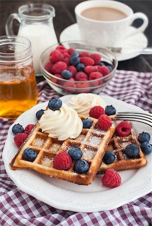 simsearch:400-07917638,k - Breakfast with belgian waffles decorated with whipped cream and fresh berries Stock Photo - Budget Royalty-Free & Subscription, Code: 400-07323724