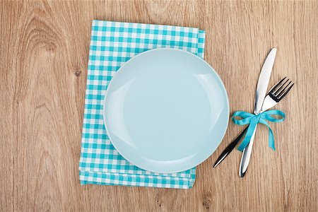 restaurant in blue with table setting - Fork with knife, blank plates and napkin. On wooden table background Stock Photo - Budget Royalty-Free & Subscription, Code: 400-07323814