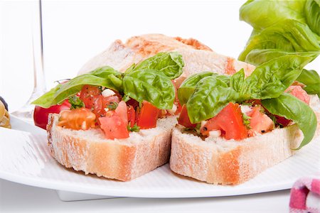 simsearch:400-06096133,k - deliscious fresh bruschetta appetizer with tomatoes isolated on white background Fotografie stock - Microstock e Abbonamento, Codice: 400-07323875