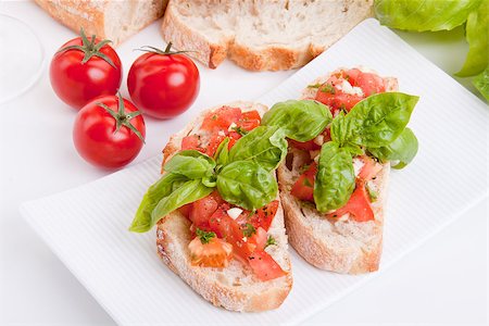 simsearch:400-06096133,k - deliscious fresh bruschetta appetizer with tomatoes isolated on white background Fotografie stock - Microstock e Abbonamento, Codice: 400-07323877