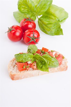 simsearch:400-06096133,k - deliscious fresh bruschetta appetizer with tomatoes isolated on white background Fotografie stock - Microstock e Abbonamento, Codice: 400-07323885