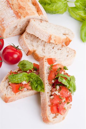simsearch:400-06096133,k - deliscious fresh bruschetta appetizer with tomatoes isolated on white background Fotografie stock - Microstock e Abbonamento, Codice: 400-07323882