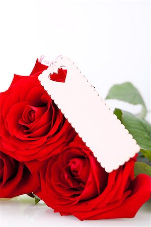 simsearch:689-03124881,k - Valentines or anniversary gift of a bunch of beautiful fragrant red roses for Love with an attached decorative blank gift tag for your greetings or message Stock Photo - Budget Royalty-Free & Subscription, Code: 400-07323999