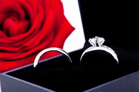 simsearch:400-07306125,k - Engagement ring or Valentines gift for a sweetheart with a bunch of red roses signifying undying love on a white background Stock Photo - Budget Royalty-Free & Subscription, Code: 400-07323992