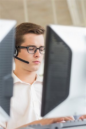 Male customer service agent using computer in call center Stock Photo - Budget Royalty-Free & Subscription, Code: 400-07334303