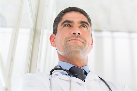 simsearch:400-07334526,k - Low angle view of thoughtful doctor in hospital Stock Photo - Budget Royalty-Free & Subscription, Code: 400-07334397