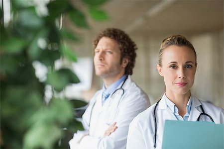 simsearch:400-07334526,k - Portrait of beautiful doctor with colleague in background at hospital Stock Photo - Budget Royalty-Free & Subscription, Code: 400-07334509