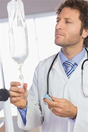 simsearch:400-07334526,k - Professional doctor examining intravenous drip in hospital Stock Photo - Budget Royalty-Free & Subscription, Code: 400-07334502