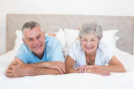 simsearch:400-07334704,k - Portrait of happy senior couple lying in bed at home Stock Photo - Budget Royalty-Free & Subscription, Code: 400-07334648