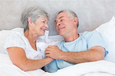 simsearch:400-07334704,k - Romantic senior couple holding hands in bed at home Stock Photo - Budget Royalty-Free & Subscription, Code: 400-07334663