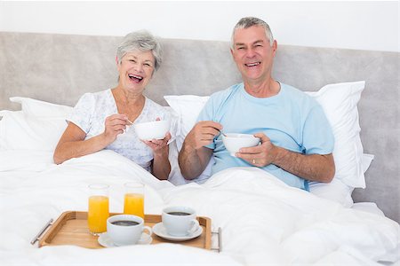 simsearch:400-07334704,k - Portrait of happy senior couple having breakfast in bed at home Stock Photo - Budget Royalty-Free & Subscription, Code: 400-07334675