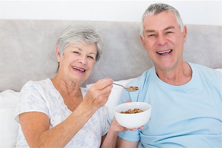 simsearch:400-07334704,k - Portrait of happy senior woman feeding cereals to man in house Stock Photo - Budget Royalty-Free & Subscription, Code: 400-07334677