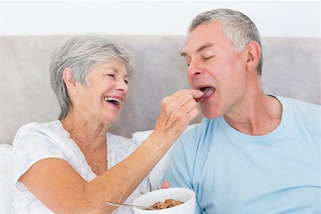 simsearch:400-07334704,k - Loving senior woman feeding cereals to husband at home Stock Photo - Budget Royalty-Free & Subscription, Code: 400-07334678