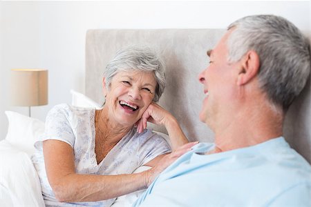 simsearch:400-07334704,k - Happy senior woman looking at husband while lying in bed Stock Photo - Budget Royalty-Free & Subscription, Code: 400-07334670