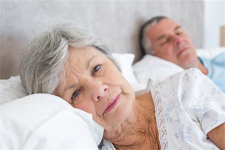 simsearch:400-07334704,k - Portrait of sad senior woman lying with man in background at home Stock Photo - Budget Royalty-Free & Subscription, Code: 400-07334672