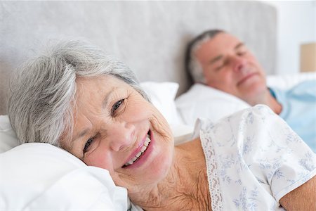 simsearch:400-07334704,k - Portrait of happy senior woman lying on bed with man at home Stock Photo - Budget Royalty-Free & Subscription, Code: 400-07334673