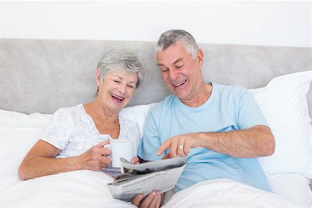 simsearch:400-07334704,k - Happy senior couple reading newspaper together in bed at home Stock Photo - Budget Royalty-Free & Subscription, Code: 400-07334686