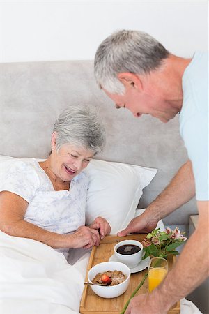 simsearch:400-07334704,k - Senior man giving breakfast tray to happy wife in bed at home Stock Photo - Budget Royalty-Free & Subscription, Code: 400-07334687