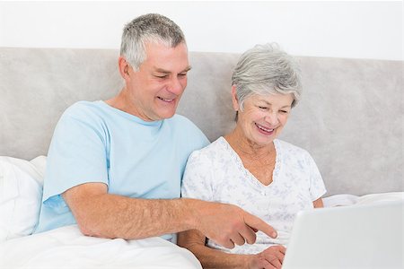 simsearch:400-07334704,k - Happy senior couple using laptop together in bed at home Stock Photo - Budget Royalty-Free & Subscription, Code: 400-07334688
