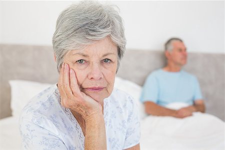simsearch:400-07334704,k - Portrait of disappointed senior woman with husband in background at home Stock Photo - Budget Royalty-Free & Subscription, Code: 400-07334708