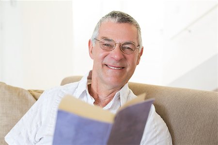 simsearch:400-04026722,k - Portrait of handsome senior man with book on sofa at home Stock Photo - Budget Royalty-Free & Subscription, Code: 400-07334717