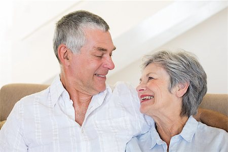 simsearch:400-07334704,k - Happy senior couple looking at each other while sitting on sofa at home Stock Photo - Budget Royalty-Free & Subscription, Code: 400-07334722