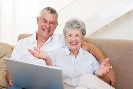 simsearch:400-07334704,k - Portrait of happy senior couple with laptop on sofa Stock Photo - Budget Royalty-Free & Subscription, Code: 400-07334730