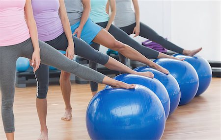 Low section of instructor and fitness class with exercise balls at fitness studio Stock Photo - Budget Royalty-Free & Subscription, Code: 400-07334837