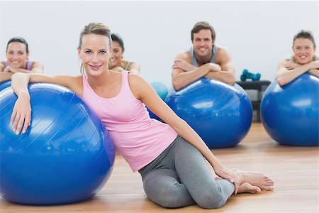 Portrait of an instructor and fitness class with exercise balls sitting at fitness studio Stock Photo - Budget Royalty-Free & Subscription, Code: 400-07334832