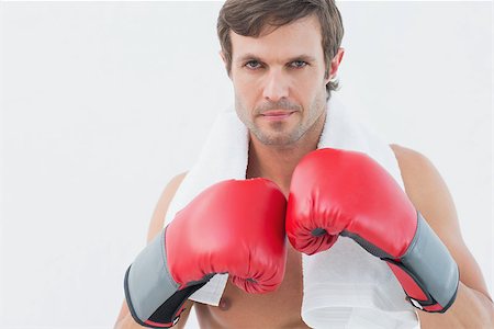 simsearch:400-06876600,k - Portrait of a serious young man in red boxing gloves over white background Stock Photo - Budget Royalty-Free & Subscription, Code: 400-07335192