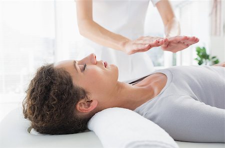 Attractive young woman having reiki treatment in health spa Stock Photo - Budget Royalty-Free & Subscription, Code: 400-07335377