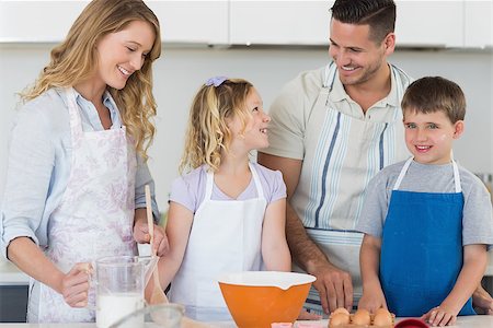 Happy family baking cookies together in kitchen at home Stock Photo - Budget Royalty-Free & Subscription, Code: 400-07335560