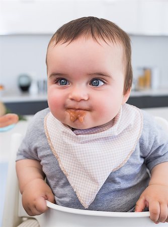 Messy baby boy eating food in kitchen Stock Photo - Budget Royalty-Free & Subscription, Code: 400-07335693