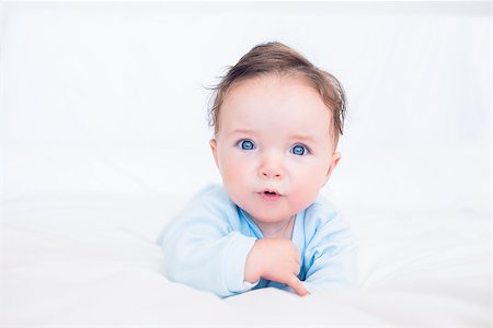 Portrait of innocent baby boy with blue eyes lying in bed Stock Photo - Budget Royalty-Free & Subscription, Code: 400-07335764