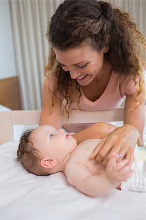 Happy mother looking at baby boy lying in crib at home Stock Photo - Budget Royalty-Free & Subscription, Code: 400-07335797