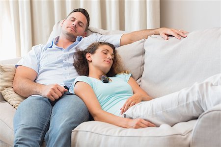 Young couple relaxing on sofa at home Stock Photo - Budget Royalty-Free & Subscription, Code: 400-07335847